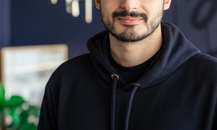 man in black and white adidas hoodie