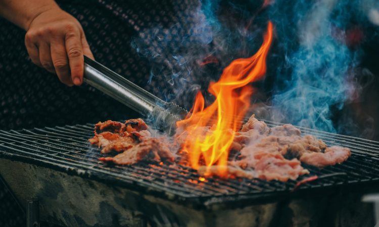 Close-Up Photo of Man Cooking Meat