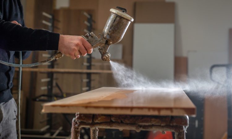 a person using a grinder on a wooden table