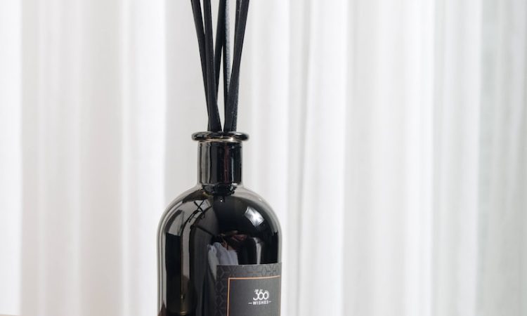 black glass bottle on brown wooden table